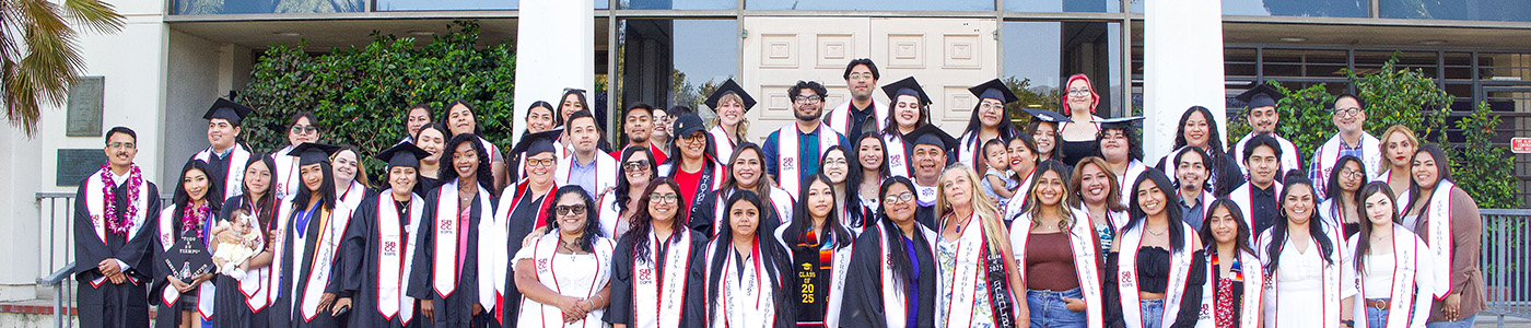 EOPS Graduates at ceremony posing for a photo